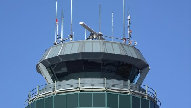 Vancouver, British Columbia, Canada. Apr 7, 2024. A close-up view of the Vancouver International Airport control tower on a clear day against a backdrop of blue sky.