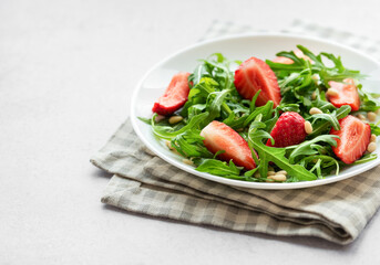 Fresh Strawberry Arugula Salad With Pine Nuts Served on a Bright Day