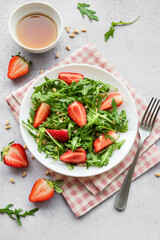 Fresh Strawberry Arugula Salad With Pine Nuts Served on a Bright Day