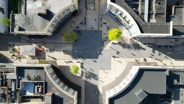 Bird's-eye view of people in Bristol's city center, browsing shops and gathering in the town square.