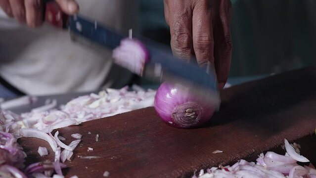 Close-up of man hand chopping onion faster.