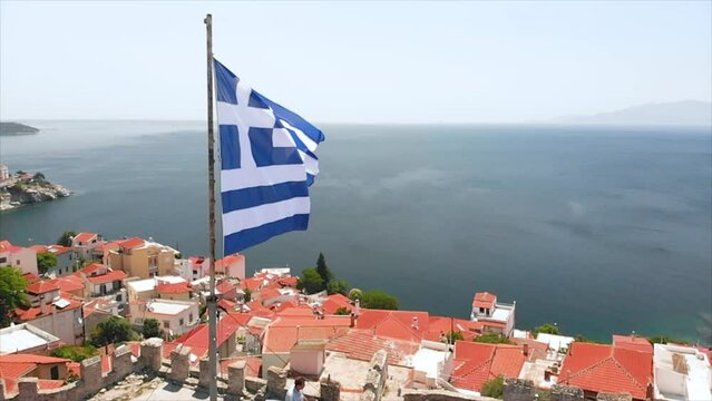 Greek Flag Waving in Slow Motion in Kavala City Castle Greece, Old Town and Sea View