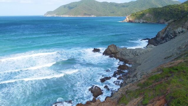 Sea Waves Crashing To The Cliff At Tayrona National Park In Colombia. - aerial shot