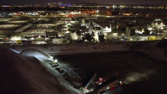 Heavy work at night, large snow remover in Montreal, Canada. From drone

