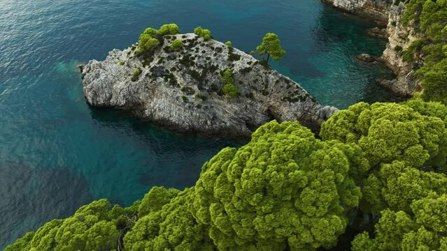 Kalamota Island, Adriatic Sea, Croatia - A Scenic View of Crystal-clear Blue Waters and Verdant Rock Cliffs - Aerial Drone Shot