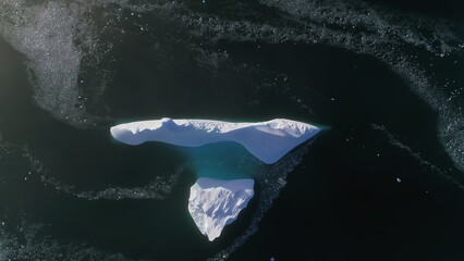 Antarctica iceberg aerial drone view flight. Fast top down. Overview the lone snow white ice...