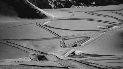 The black and white image of the delivery trail stretching along the snowy road