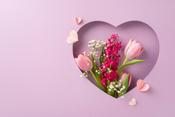 Celebrate Mom: Top view of tulips, hyacinth, gypsophila, and paper hearts framed in heart cutout on...