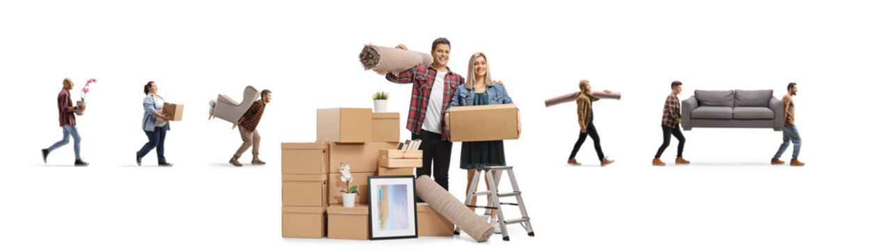 Couple with a cardboard boxes and movers in the back carrying items