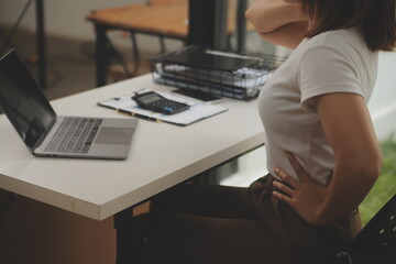 Shot of a asian young business Female working on laptop in her workstation.