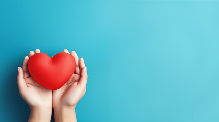Hand holding red heart on aqua background, Donation, CSR concept, World heart day, world red cross...