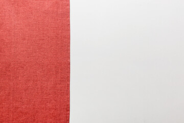 Fototapeta premium top view with red empty kitchen napkin isolated on table background. Folded cloth for mockup with copy space, Flat lay. Minimal style