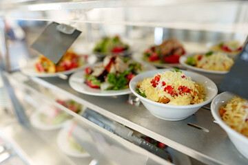 Freshly Prepared Salads on Display in a Cafeteria During Lunchtime