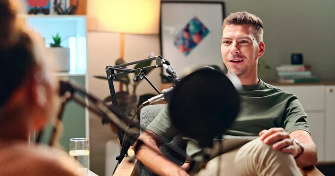 Happy man, interview and podcast with celebrity in meeting for discussion, conversation or news at studio. Young male person talking on air together with mic for communication, live chat or recording