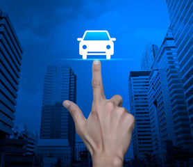 Hand pressing car flat icon over modern city tower and skyscraper, Business transportation service concept