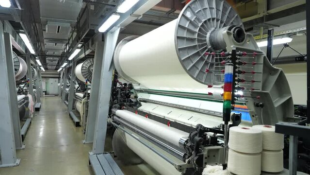 working weaving looms in a weaving factory workshop, fabric making, weaving