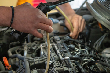Fototapeta na wymiar photo of a mechanic's hands repairing a car diesel engine