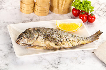 Baked Dorado fish served lemon