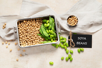 Soybeans on light cotton and wooden background. Vegan food concept.