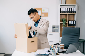 Happy and excited young beautiful Asian woman office worker celebrating her resignation, carrying her personal stuff. leaving job, changing or company.