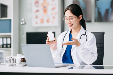 female doctor sitting on work desk Medical online, e health concept. Doctor using laptop for work, video call video chat .