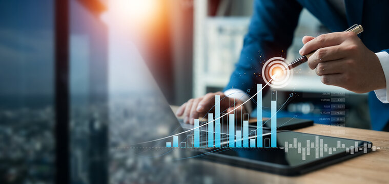 Businessman use laptop and tablet analyzing company growth, future business growth arrow graph, development to achieve goals, business outlook, financial data for long term investment.