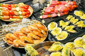 Vibrant street food grill showcases succulent shrimp and diverse seafood, tempting with freshness, steam, and a feast of colors, embodying the spirit of outdoor culinary adventures