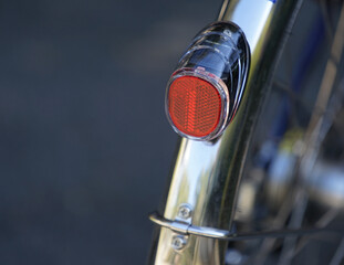 Red reflector on the rear wheel of the bicycle