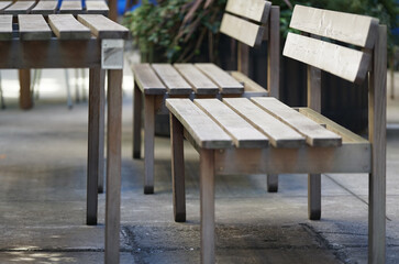 Wooden benches and tables in a café on a city street
