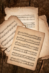 Old Music Sheets On Wooden Background - 782872549