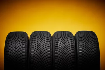 Fotobehang Car tires, winter wheels isolated on yellow background and screwdriver © ValentinValkov