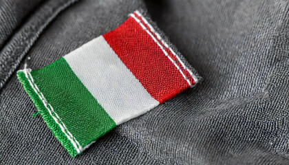 Extreme close-up of a clothing label with the Italian flag sewn on a dark grey fabric. Made in Italy concept. Generative Ai.