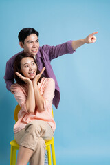 Obraz premium Photo of young Asian couple on blue background