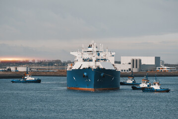 LNG Tanker Mooring In The International Trade Port. Gas Transportation Facility. Natural Gas Shipping And Logistics.