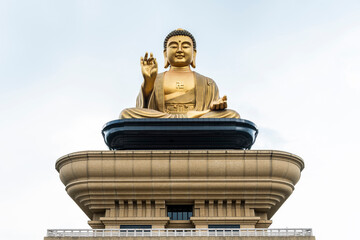 Close-up of the giant Buddha statue with the blue sky background