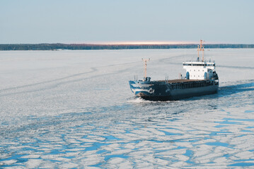 General Cargo Ship Sailing Underway In The Frozen International Shipping Fairway Route. Water Surface Covered With Ice. Winter Navigation in The Arctic Area Region. © I am from Mykolayiv