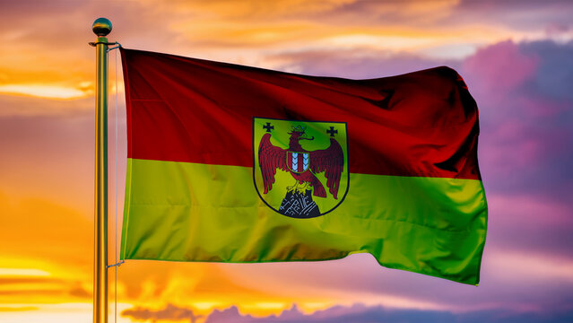 Burgenland Waving Flag Against a Cloudy Sky at Sunset.