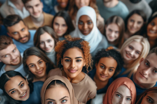 Diverse group of smiling people looking up with positive vibes