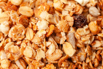 Muesli oat cereals with raisins, dried fruits and sunflower seeds background. Top view. Close-up