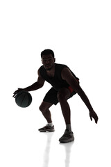 Fototapeta na wymiar Silhouette of young concentrated young man, basketball player in motion during game, dribbling ball isolated on white background. Concept of professional sport, competition, game, tournament, action
