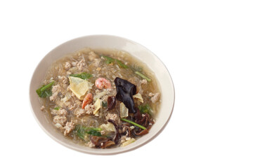 Clear vermicelli soup with minced pork, dried shrimp,mushroom, other ingredients in bowl, isolated...