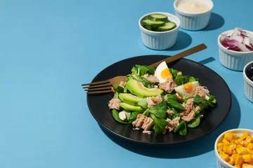  Salad with tuna on a blue background. © Atlas