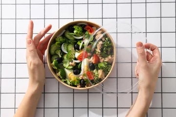  Tuna salad in a cardboard plate on a light table. © Atlas