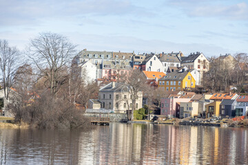 walking along nidelven (river) in a spring mood in trondheim city, trøndelag, nidelven, water, river, landscape, sky, nature, city, reflection, view, trees, clouds, travel, architecture, house, buildi - 782892189