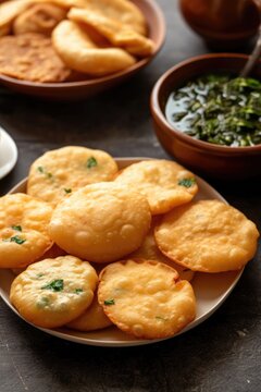 Closeup Image of Delicious Indian Crunchy Kachori with Sauce Served on Plate, Ready to be Eaten and Enjoyed.