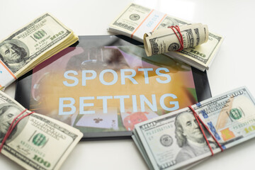 tablet pc with app for sport bets, on top of stacks of banknotes, white background, concept of online bets 3d render