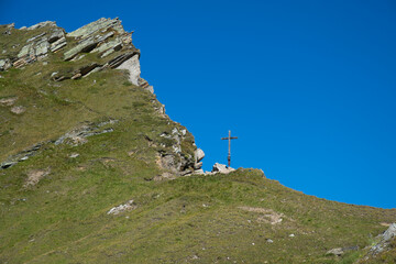 View of the summit cross of Giogo Lungo Alm in Alto Adige, Italy - 782905382