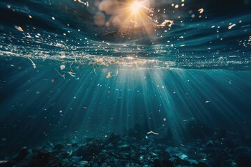 Underwater photography, the ocean is full of plastic waste and garbage floating in it, sun rays shining on water surface.