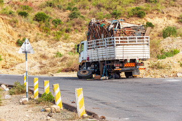 Damaged old truck by the road. A trucks wheel fell off. A common view of transportation in Ethiopia. Oromia Region. Ethiopia