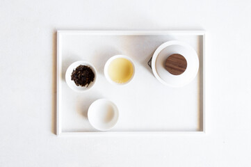Asian tea concept, Top view of minimalist tea set with white cups of tea and teapot